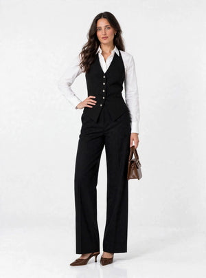 Noir Halter Vest - hand on waist with brown bag